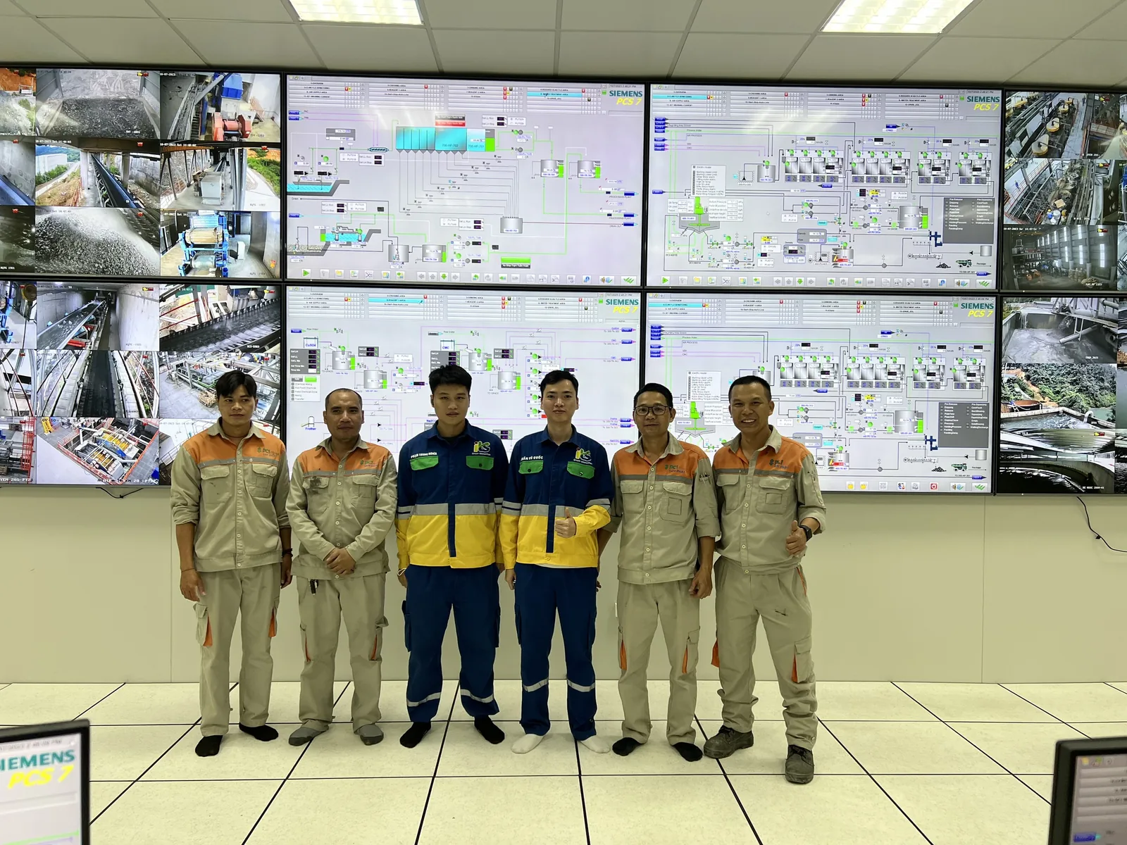 ITS engineers in front of a control center video wall