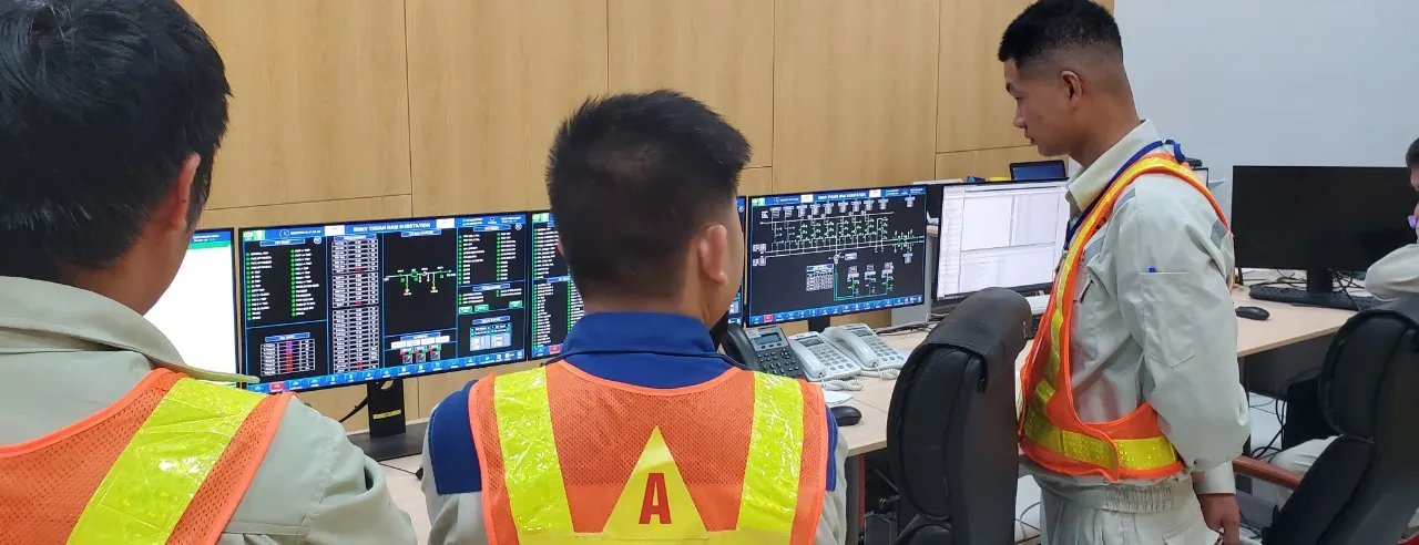 ITS engineers configuring SCADA workstations in a substation control room